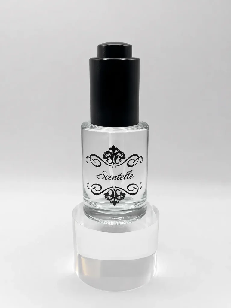 Scentelle 1 oz push-button dropper body oil in a glass bottle with clear liquid and a black dropper cap.