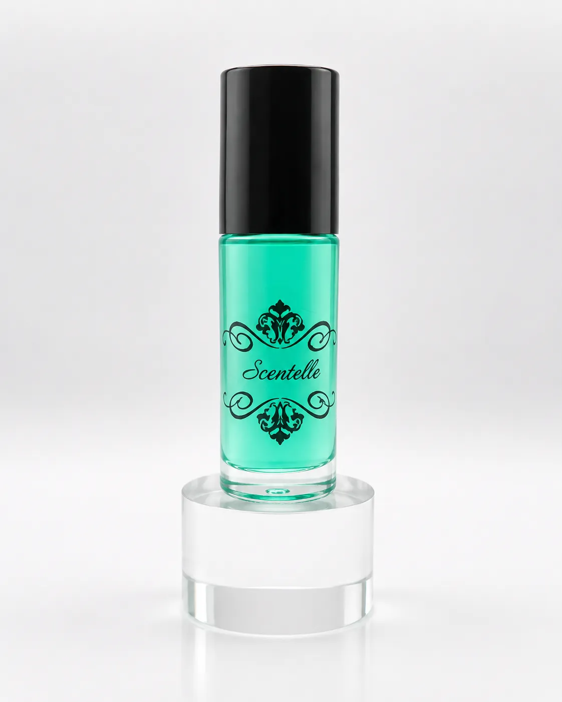 Scentelle 1 oz roll-on perfumed body oil in a thick glass bottle with green liquid, a black cap, and an ornate logo.